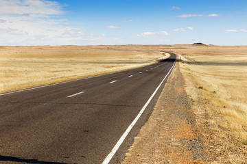 asphalt road Sainshand Zamiin-Uud in Mongolia, beautiful landscape Gobi Desert