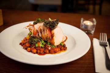 pork on a bed of chickpeas intomato sauce