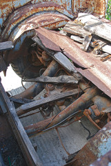 Close-up of transmission and remnants of a wooden body of an old rusty pickup truck, Rhodes Island, Greece