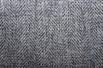The texture is wool.Wool background with herringbone pattern.Thick woolen fabric.