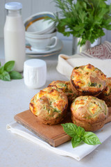 Freshly baked muffins with spinach, sweet potatoes and feta cheese on white background. Healthy food concept. Savory pastry.