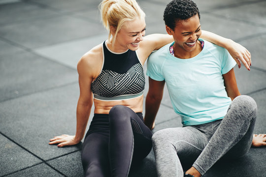 Two Fit Young Women Laughing Together After A Gym Workout