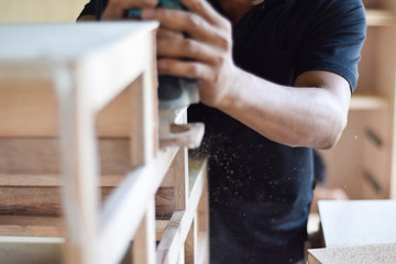 Carpenter working with planed wooden