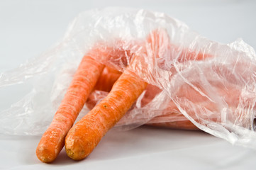 Carrots in plastic bag isolated on white