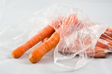 Carrots in plastic bag isolated on white