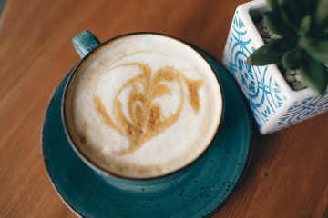 a cup of coffee. cappuccino. patterned cream.  a heart