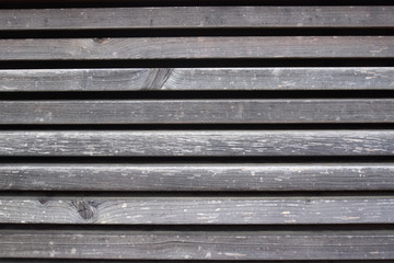 Texture of grey weathered wood planks with gaps.