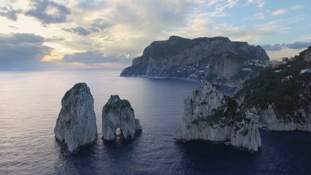 Faraglioni rocks towering up from bright blue Mediterranean. Capri, Italy