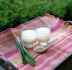 Barley water in glass and cooked pearly barley with pandan leaves