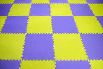dirty playground mat for children in public place, blue and yellow color rubber jigsaw.