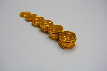Sweet chocolates are in the form of gold coins. Gold cents with a beautiful overflow and gold reflections, in the style of antiques. Financial market, valuable coins, gold money and bills.