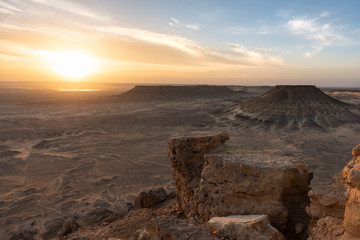 Sunset landscape over the salt lake of Bahariya oasis as seen from the top of Jebel Dist
