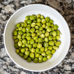 Bowl full of green peas ready to eat