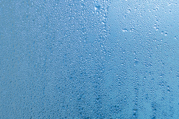 Natural water drops on window glass