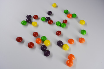 A lot of round sweets like tablets, medicine with bright color and taste. This color sweets are round beads, rainbow color stones. It's popular delicious colorful sweet with sweaty and lively form.