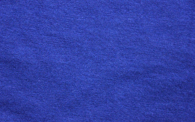 Fototapeta premium Navy blue dark fabric texture background top view banner. Classic blue cloth empty canvas, seamless casual fashion clothes material, flat lay wallpaper or banner of vibrant blue surface