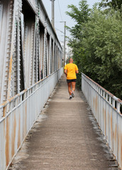 Obraz na płótnie Canvas sportsman on an old railway bridge