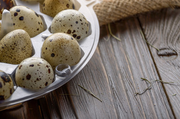 Fresh organic quail eggs in plastic tray on hemp fabric burlap. Space for text