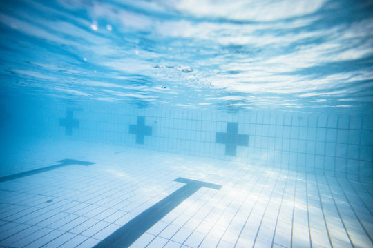 Wide angle underwater photo inside an olympic sized swimming pool with racing lanes