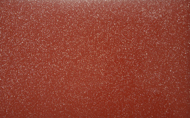 Red pearlescent transparent background with metal splashes. Background. Texture. Close-up.