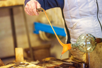 The processing of Murano glass, Venice, Veneto, Italy. A master glassmaker working with the most...