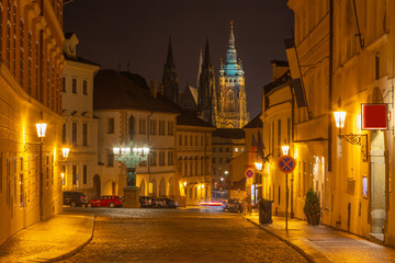 Prague - The St. Vitus cathedral and the LoretÃ¡nskÃ¡ street at night..