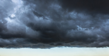 Dark cloud with a clear edge of the storm cloud, in front of a thundery front, weather changes