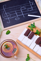 Piano keyboard made up of white vanilla pastila and chocolate sweets