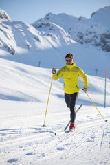 Fototapeta na wymiar Cross-country skiing: young man cross-country skiing on a winter day