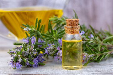 Rosemary essential oil in a small bottle. Natural aroma cosmetic oil