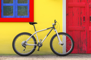 Fototapeta na wymiar Bicycle Parked in front of Retro Vintage European House Building with Red Door, Blue Window and Yellow Wall, Narrow Street Scene. 3d Rendering