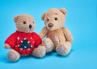 two teddy bears are sitting side by side