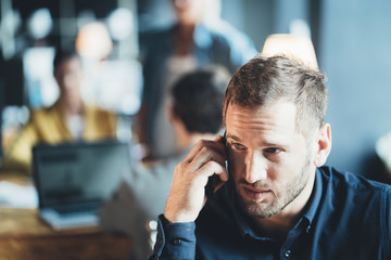 Man employee sitting at the office talking on the phone