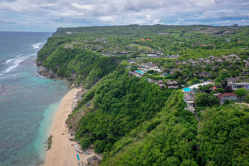 Obraz premium Tropical beach with high green cliffs, aerial view, Melasti beach, Bali, Indonesia