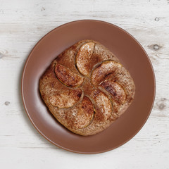 Gluten free homemade apple pie with almonds on white wooden background