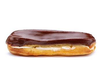 Traditional french dessert. Isolated eclair with custard and chocolate icing on white background....