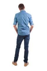 Fototapeta premium Back view of man in dark jeans.