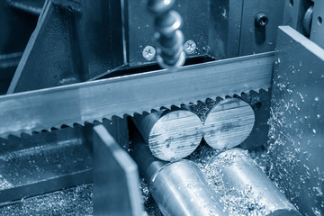 The  band saw machine cutting raw metals rods .The industrial sawing machine cutting the material...