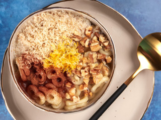 Romanian mucenici or macinici: figure eight shaped pasta, boiled in water with sugar, cinnamon and crushed nuts. Traditional dessert for the Christian feast of the 40 Martyrs of Sebaste