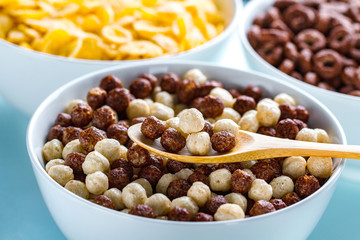 Dry, cereals breakfast. Spoon and bowl with chocolate white and brown balls