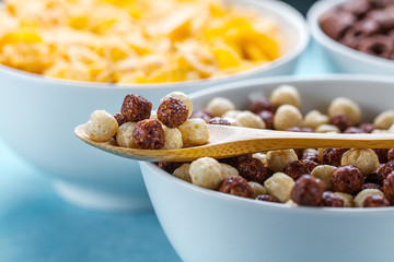 Dry, cereals breakfast. Spoon and bowl with chocolate white and brown balls