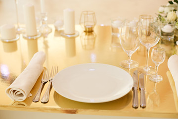 Golden color table setting. Silverware and cutlery.