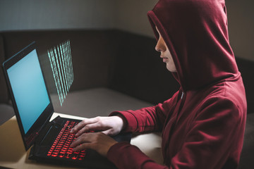 Naklejka premium Dangerous hooded woman hacker breaks into personal data and infects system with a virus. Hacker attack, cyber security. Hacking and identity theft, fraud, scam concept