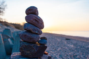 pyramid of stones in the rays of the setting sun