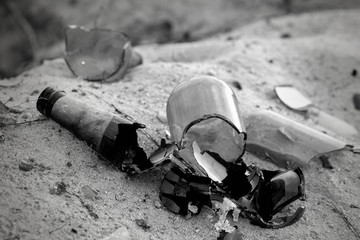 Broken beer glass bottles on a sand