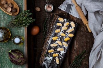 pumpkin gnocchi uncooked on the wooden board