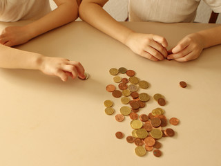 Kids hands with coins on white background close up. Concept business