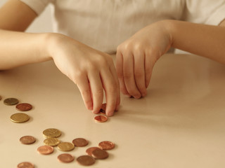 Kids hands with coins on white background close up. Concept business