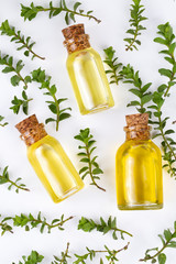 A bottle of thyme essential oil with fresh thyme