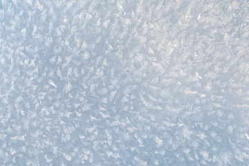 Crystallized weathered snow background. Natural prickly snow 